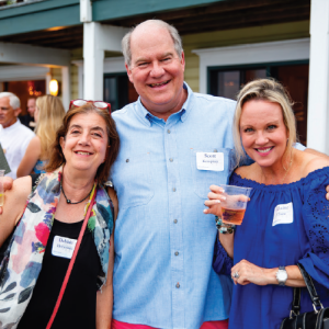 Scott poses with friends, Debbie Heineman (left) and Elaine Chase (right) with a big smile in the 2023 TILT Summer Gathering at the TI Park Pavilion.